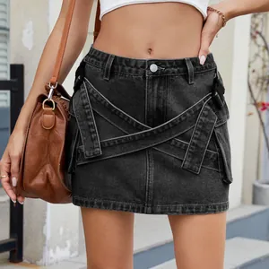 Detail view of washed black cargo denim mini skirt with unique pocket and strap design