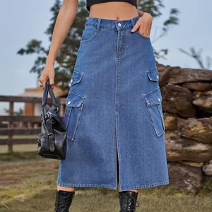 Outdoor view of a blue denim cargo midi skirt with pockets and center slit.