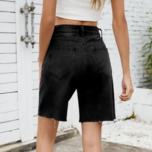 Back view of washed black denim shorts with stylish frayed raw edges for women