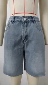 Close-up detail of high-waisted women's washed straight-leg denim shorts with raw hem