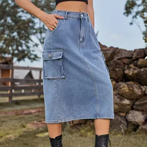 Detail view of washed blue denim cargo midi skirt with side flap pocket on model