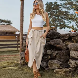 Detail view of a washed khaki cargo denim midi skirt with front slit and drawstring