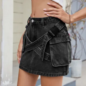 Close-up detail of a black washed cargo denim mini skirt featuring cross straps and buckle