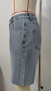 Side view detail of light washed denim shorts with raw edge finish on mannequin