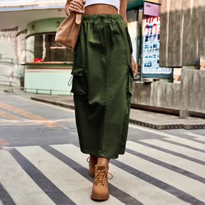 Detail view of an olive green cargo maxi skirt with drawstring and utility pockets.