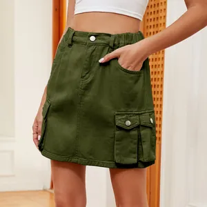 Detailed view of a green cargo denim skirt with multiple functional pockets.