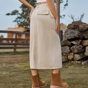 Detail view of a khaki cargo denim maxi skirt featuring side flap pockets and back silhouette