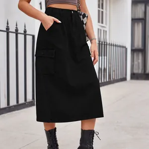Close-up view of a black cargo denim midi skirt featuring a large utility side pocket