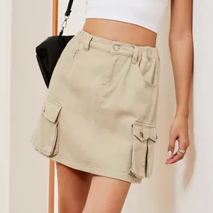 Close-up view of a khaki washed denim cargo mini skirt featuring large utility side pockets