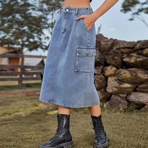 Close-up detail of a washed denim cargo midi skirt featuring a large side flap pocket