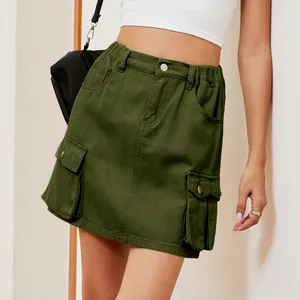 Detail of washed olive green cargo denim mini skirt with multi-pockets and elastic waist