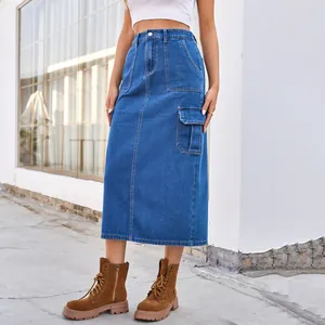 Detail view of a stylish high-waisted washed blue denim cargo midi skirt on model