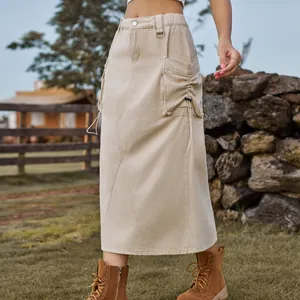 Detail of a vintage khaki denim cargo midi skirt with drawstring pockets outdoors.