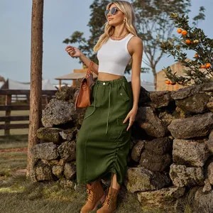 Outdoor fashion shot of a woman in an army green drawstring cargo denim midi skirt.