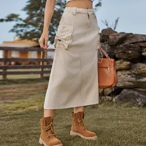 Detail view showing cargo pockets and drawstring on a vintage khaki denim midi skirt