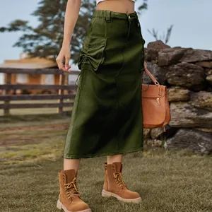 Vintage dark olive green cargo denim midi skirt with drawstring pockets in rural setting