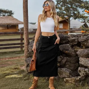 Detail shot of a black vintage cargo denim midi skirt on a model in a rustic outdoor setting.