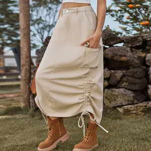 Detailed view of a beige denim cargo midi skirt featuring side pocket and drawstring