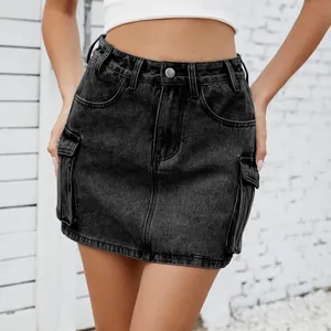 Close-up detail of a washed black denim cargo mini skirt featuring functional side pockets