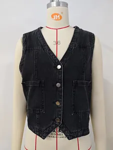 Detailed close-up of a black washed denim vest featuring metal buttons and pockets.