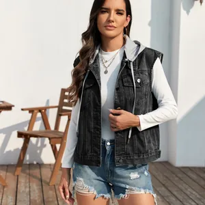 Detail of a classic washed black denim vest with a grey jersey hood on a female model.