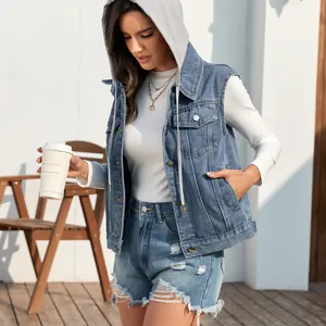 Detail shot of a casual washed denim vest with hood worn with distressed shorts