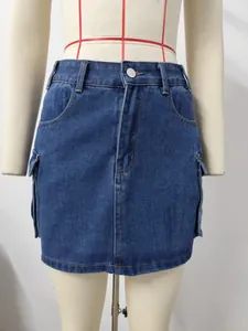 Front view detail of a retro washed blue denim cargo mini skirt with flap pockets