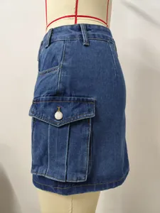 Close-up view of the washed denim cargo pocket with a white button on a short skirt