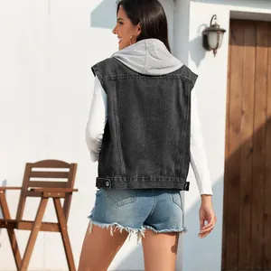 Detailed back view of a classic black washed denim vest layered over a white hooded sweater.