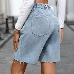 Close-up back view of vintage denim Bermuda shorts with raw hem and classic pockets