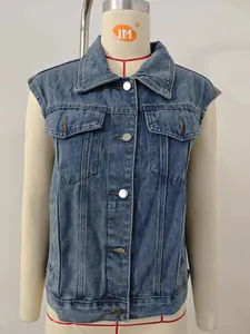 Close-up of a women's classic washed blue denim vest with silver buttons and pockets