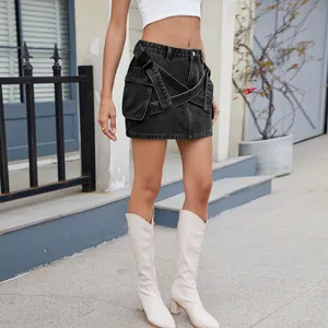 Detailed shot of a black denim cargo skirt with stylish crisscross straps and pockets