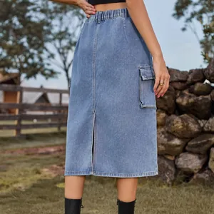 Detailed back view of a washed blue denim cargo midi skirt with a slit and elastic waist