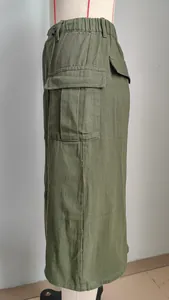 Side view detail of a stylish army green washed denim cargo midi skirt on a mannequin.