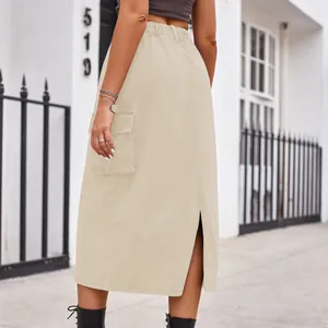 Back view of beige cargo denim midi skirt with elastic waist and side pocket details