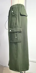 Side detail of army green denim cargo skirt with large pockets and elastic waist