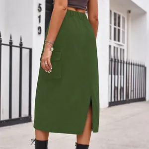 Detailed back view of a green cargo denim midi skirt featuring a slit and elastic waist
