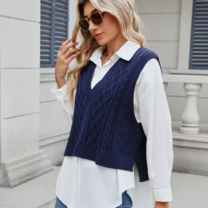 Detailed view of navy blue cable-knit V-neck sweater vest with stylish side slits.