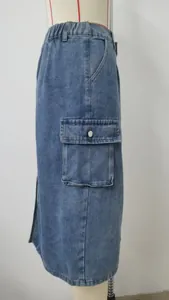 Detailed side view of a washed blue denim cargo midi skirt featuring a functional flap pocket