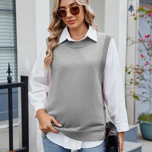 Detail view of stylish grey knit vest featuring side buttons and slits over white shirt