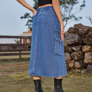 Outdoor view of a blue denim cargo midi skirt with elastic waist and pockets.