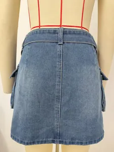 Back view detail of blue washed denim cargo skirt with side flap pockets on mannequin