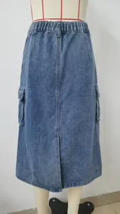 Front view of washed blue denim midi cargo skirt with elastic high waist and side pockets