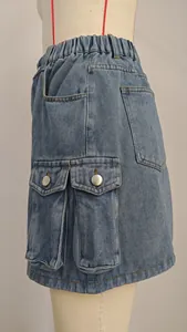 Close-up of washed denim cargo mini skirt with functional side pockets and elastic waist.