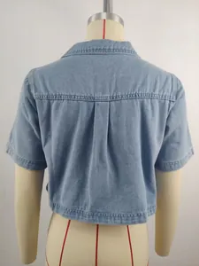 Detailed back view of a light blue washed denim cropped jacket with pleated back