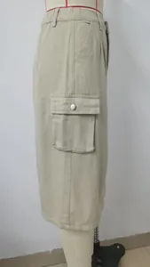 Side detail of a khaki cargo denim midi skirt with a large flap pocket