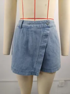 Close-up detail of irregular washed denim skort on mannequin showing front overlap design
