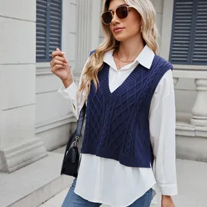 Close-up of women's navy blue V-neck cable knit sweater vest styled with a white shirt