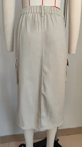 Back view of khaki washed denim cargo midi skirt featuring elastic waist and utility pockets