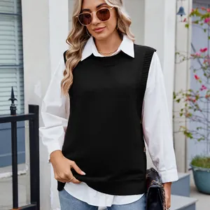 Casual black sleeveless knit vest with decorative side buttons layered over a white shirt.